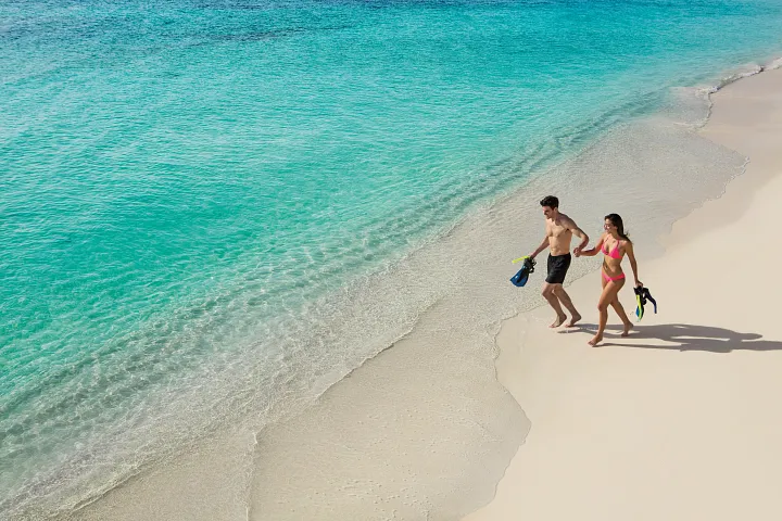 secrets-akumal-snorkeling-couple-walking-beach